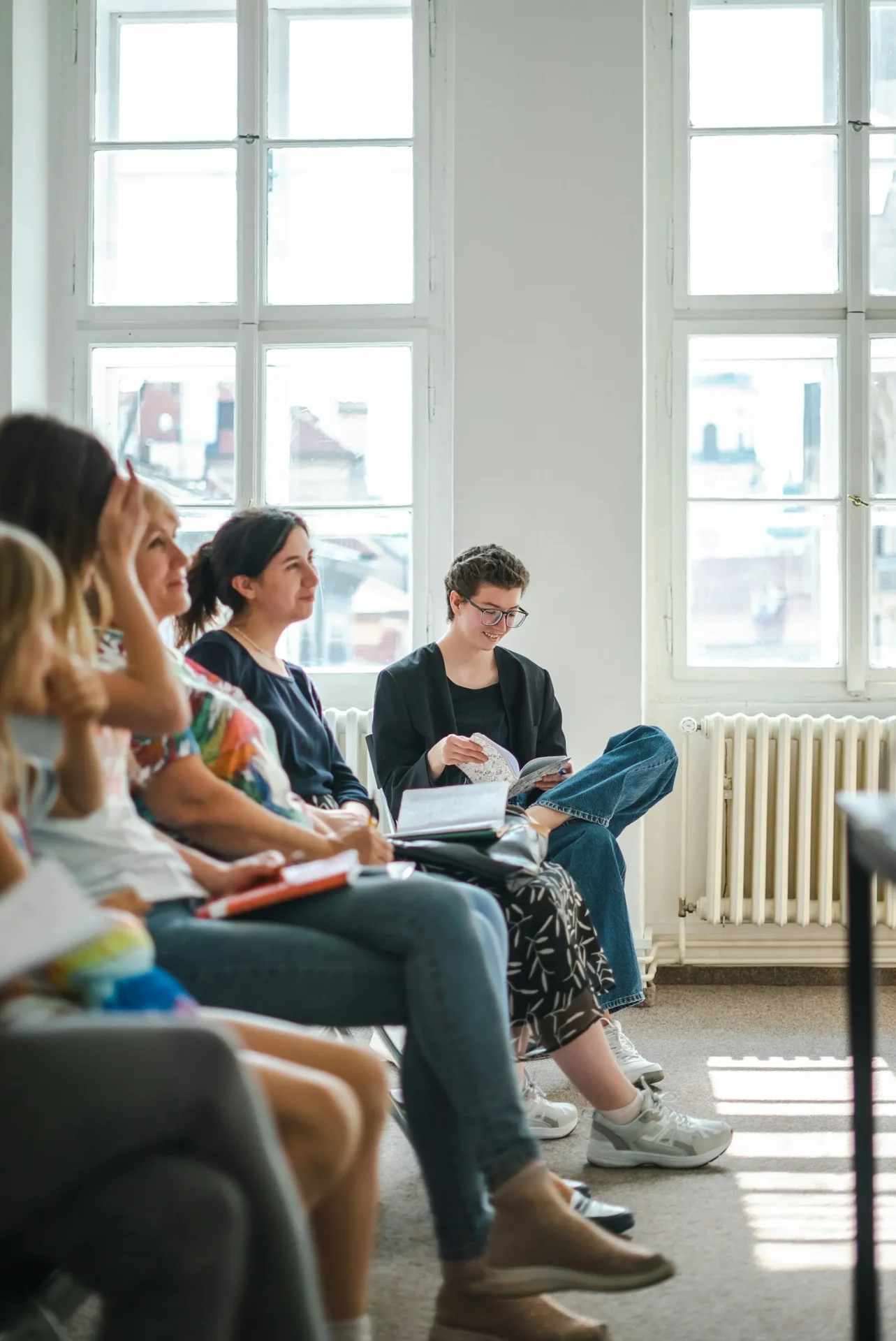 timur-shakerzianov-YlPCH249qHE-unsplash Group of people talking during a counselling session.